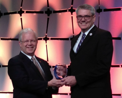 Dr. Michael Earley, right, accepts the AOA’s Educator of the Year award from Immediate Past President Dr. Ronald L. Hopping.