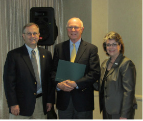 Dr. John Amos (center) receives his resolution. He is pictured with Drs. Larry J. Davis and Dr. Linda Casser.